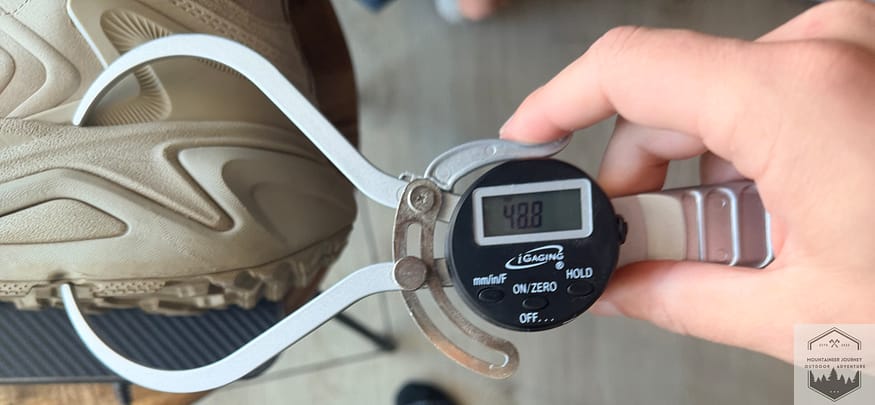 Measuring heel stack height on Hoka Kaha 3 at 48.8 mm with our caliper