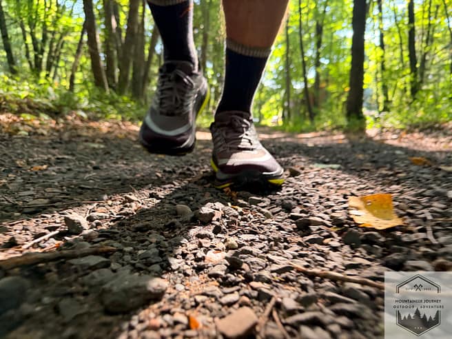 Ground-level view of the Hoka Stinson 8 while trail running up gravel and packed dirt