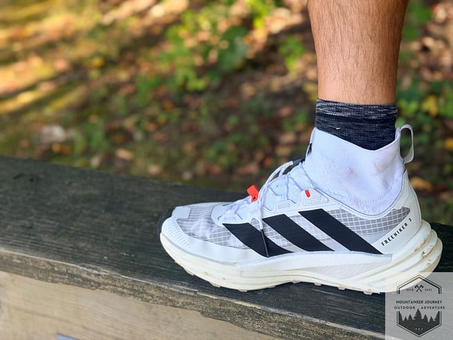 Adidas Terrex Free Hiker 3 mesh ankle view while standing on wood.