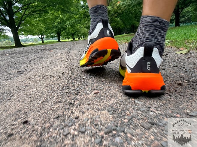 Heel view of Altra Olympus 7 during stability testing on gravel
