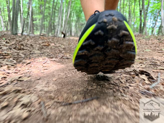 View of the forefoot on the Cascadia 20 while midfoot striking on the trail. The outsole is covered with dirt. We are testing the foot protection in this picture