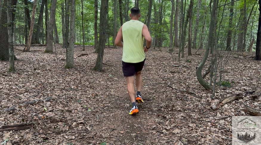 Running on dirt packed trail during the testing of the Altra Olympus 7, noting the impact absorption