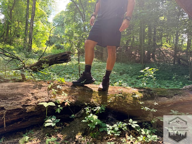 Standing on top of log during testing of boots