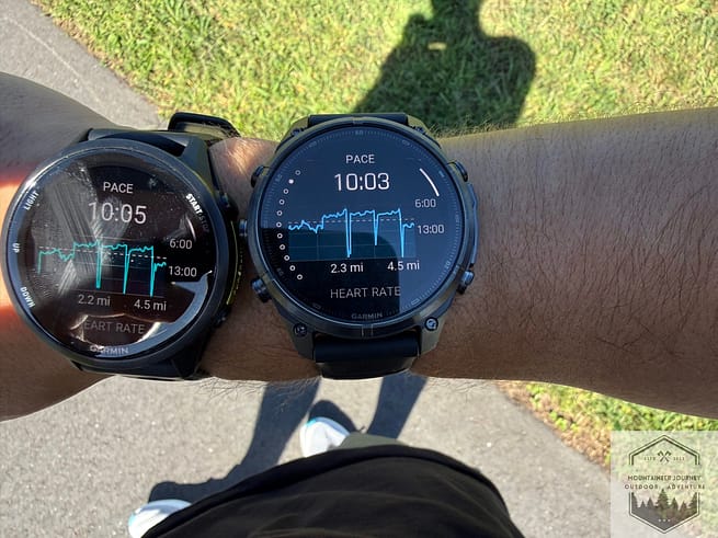 Fenix 9 and Forerunner 970 worn on the same wrist, the Fenix is much bulkier and less subtle on the wrist.
