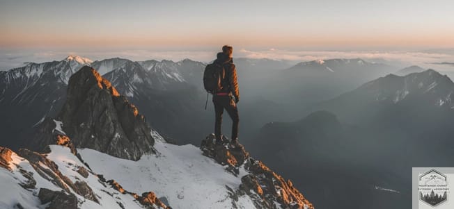 Solo hiker at top of mountain summit