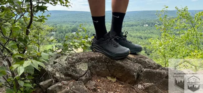 Standing at the top of a mountain summit with Altra Ultra Olympus 6