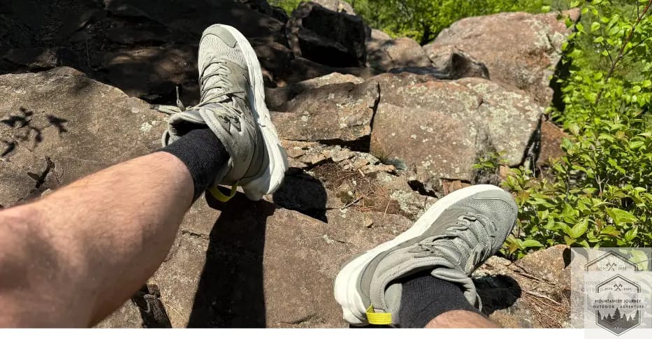 Wearing darn tough light socks while resting on rock