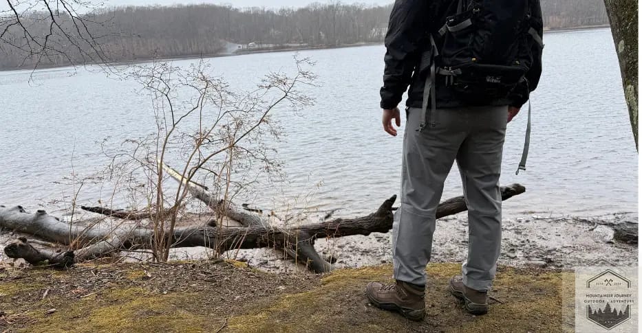 solo hiker at edge of water
