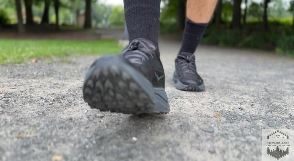 Testing the Hoka Challenger 8 impact absorption on gravel, showcasing the high-stack CMEVA midsole designed for a plush road-to-trail transition.