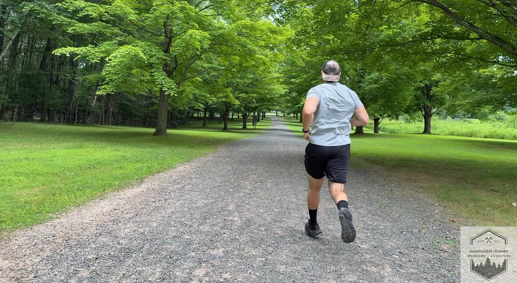 Testing the Hoka Challenger 8 traction on a loose gravel path to evaluate the grip of the 4mm multi-directional lugs and Durabrasion rubber on mixed terrain.
