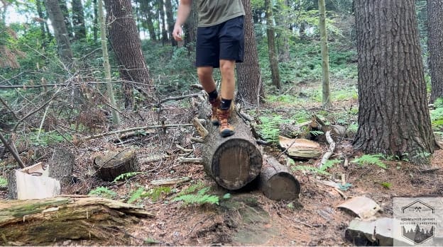 balancing on a wood beam during hike
