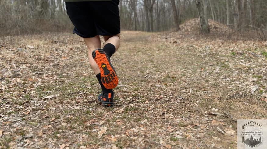 Altra Lone Peak 9+ stability test on technical trail, highlighting the Vibram Megagrip lug pattern and wide stable platform.