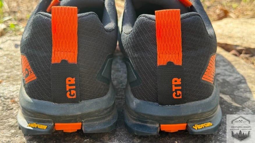Backside view of the Altra Lone Peak 9+ highlighting the hook-and-loop GaiterTrap and the reinforced heel pull tab.