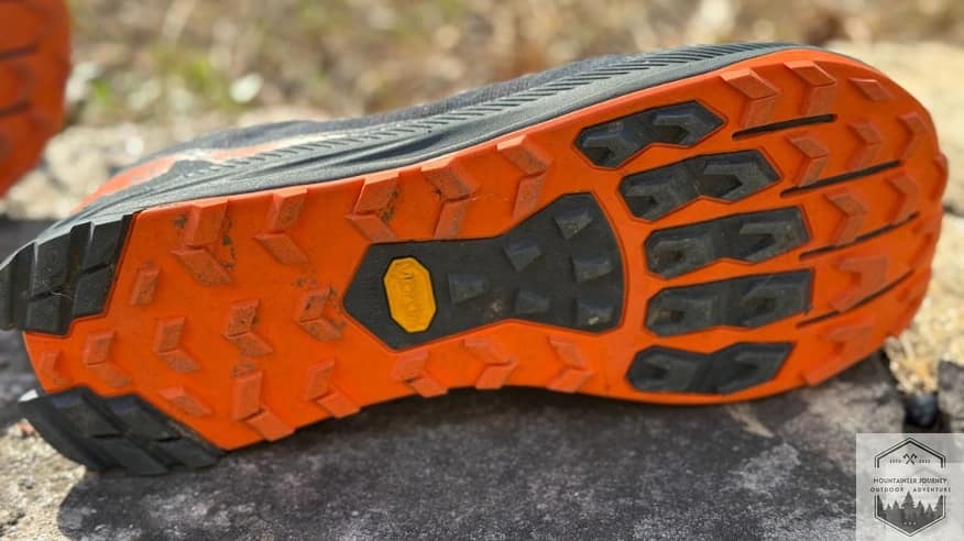 The Altra Lone Peak 9+ Vibram Megagrip outsole featuring widely spaced lugs designed for superior traction and mud shedding.