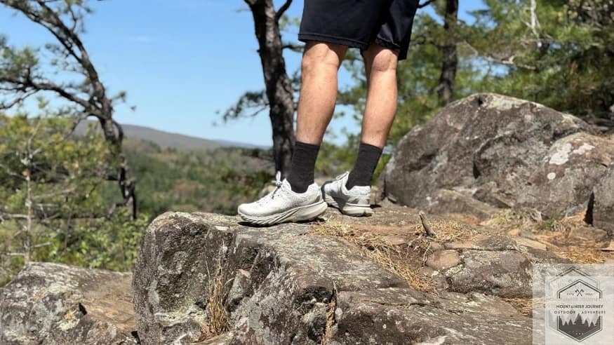 Standing the top of a summit wearing the Merrell Agility Peak 5's on a rock