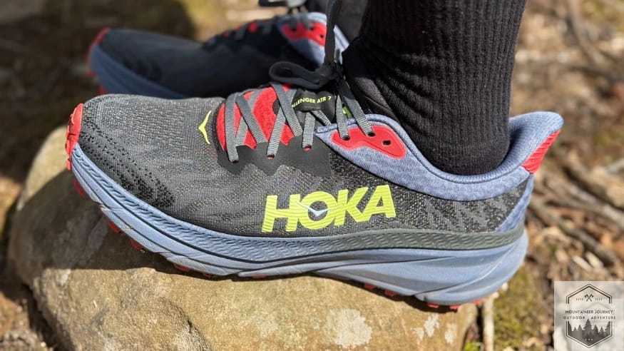 Side view of the hoka challenger 7, resting on a rock