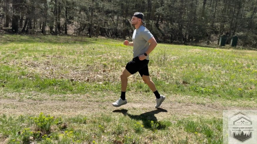 Running in the Merrell Agility Peak 5 on a flat dirt trail to test the lateral stability of the high-stack FloatPro midsole.