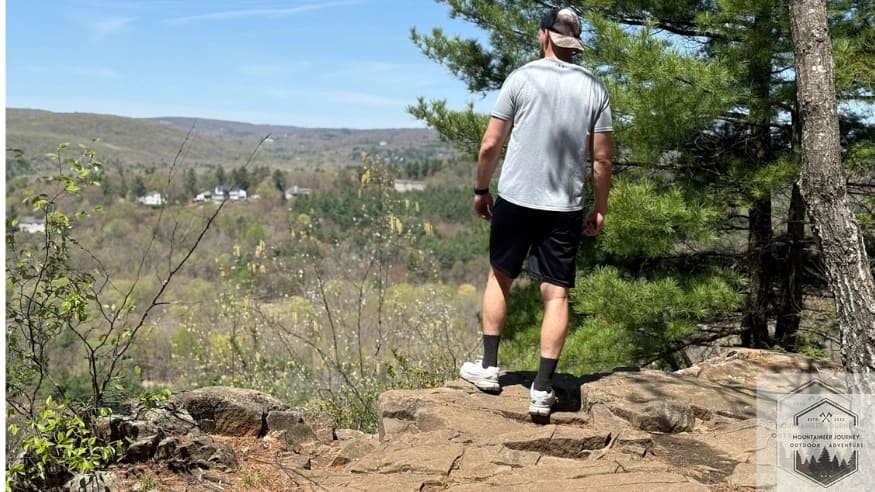 Standing at a mountain summit after a technical trail run in the Merrell Agility Peak 5 to verify long-term comfort and traction.