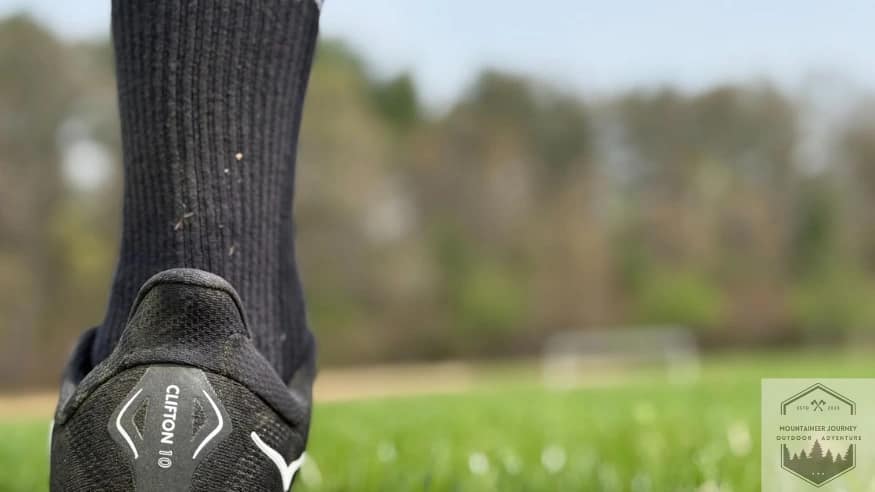 Rear view of Hoka Clifton 10 showing heel tab and wide outsole base for walking stability