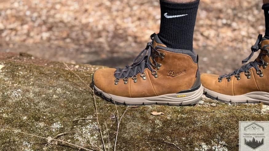Showing the Vibram megarip outsole holding grip onto a large tree branch on the ground