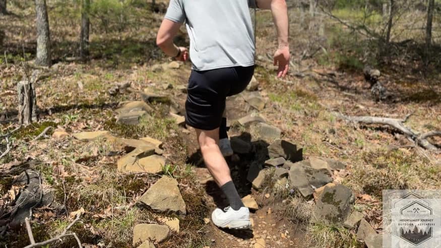 Action shot of the Merrell Agility Peak 5 on a technical ascent, testing the lateral stability and forefoot support of the FloatPro midsole.
