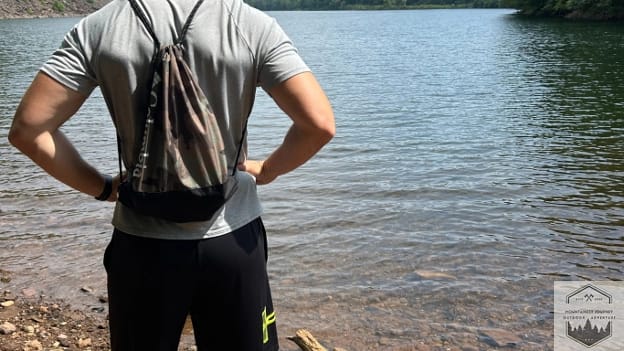blog-img-1722802586509 hiking gear with backpack, boots, over a lake