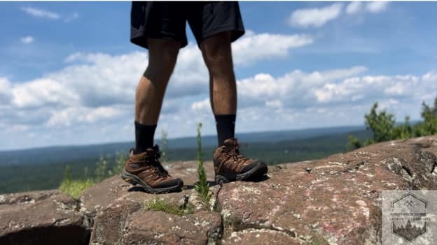 blog-img-1722538445264 Merrell Moab 3 summer hiking boots at the top of a rock showcasing breathability