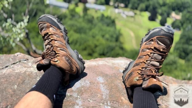 blog-img-1721426669905 Merrell Moab 3 hiking boots at the mountain summit after a high-elevation ascent, showcasing the durability and comfort of the Ventilator mesh upper in alpine conditions.