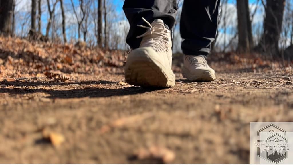 Front view of Hoka Kaha 3 hiking boots on dirt trail testing.