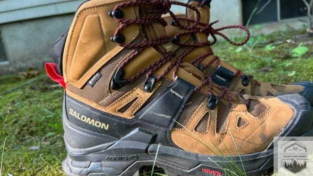Lateral view of the Salomon Quest 4 GTX in the grass. Showcasing the ADV-C chassis