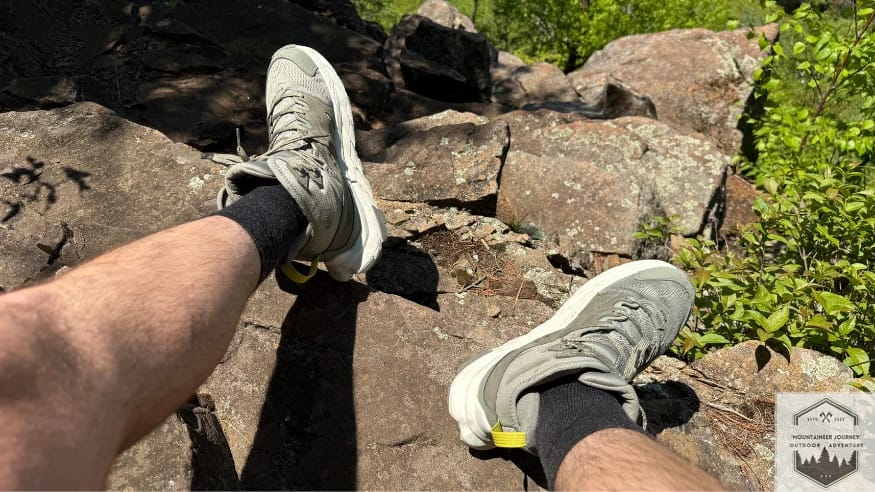 sitting at the top of a rock wearing the boots