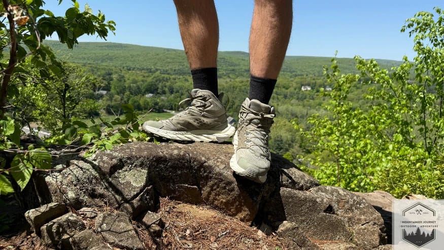 Standing on a rock wearing the Hoka Anacapa Breeze 2
