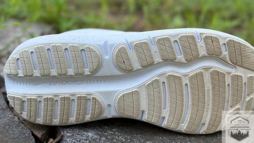Durable rubber outsole of the Brooks Ghost Max 2 showing the wide base for stability and segmented design for smooth heel-to-toe transitions on road runs.