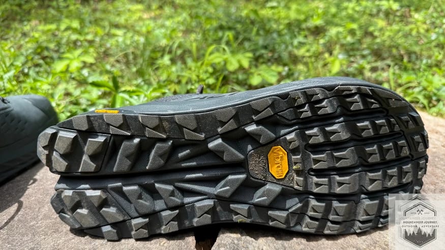 Bottom view of the Altra Olympus 6 Vibram Megagrip outsole showing aggressive lug depth and the wide lateral stability flare.