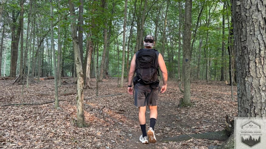 Testing the Hoka Transport on a hiking trail to evaluate the grip of the Vibram outsole on loose dirt and uneven terrain