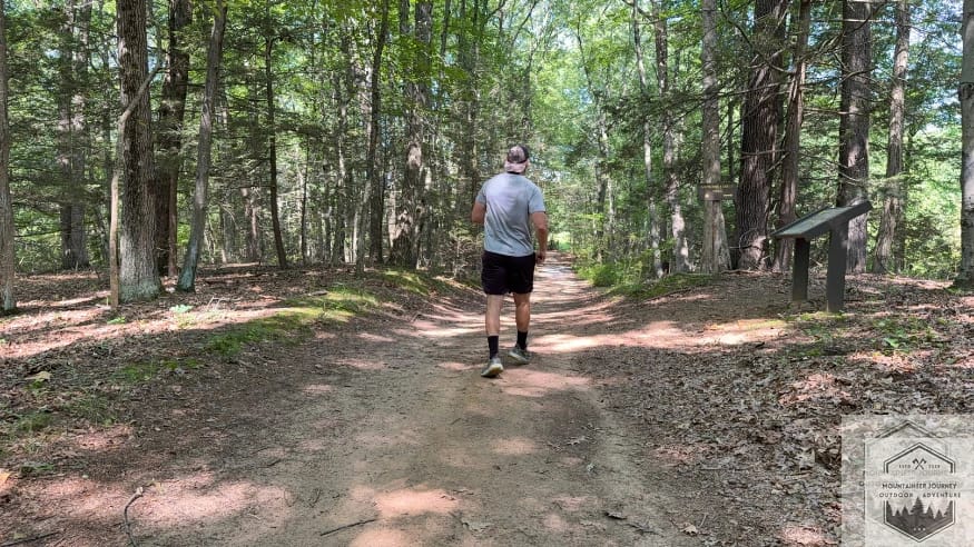 Field testing the Hoka Stinson 7 on an inclined dirt path to evaluate the Meta-Rocker propulsion and H-Frame stability during climbs.