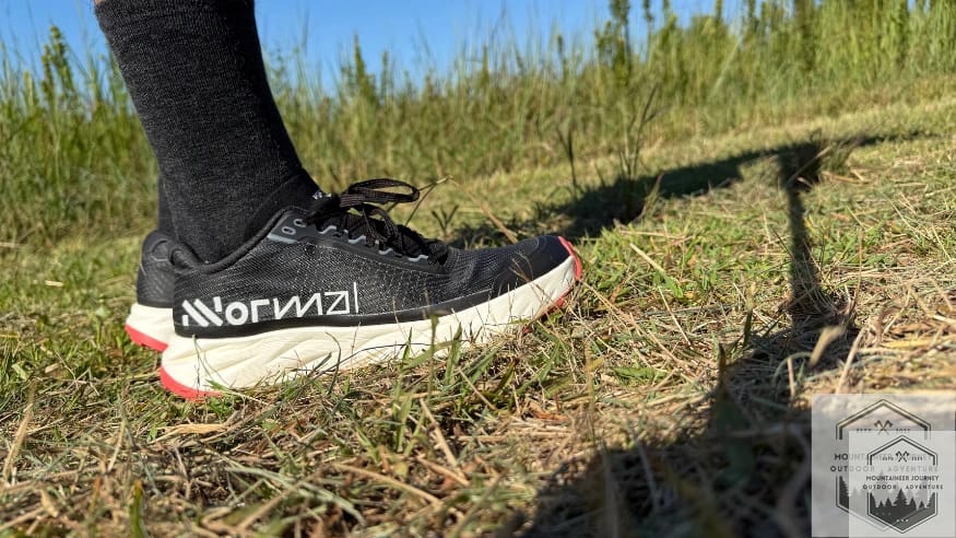 Wearing NNormal Kjerag 2 trail running shoes on grass during testing.