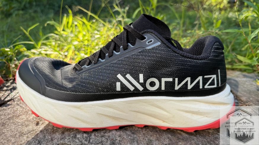 Profile view of the NNormal Kjerag 2 sitting on a wall, displaying the midsole geometry and upper design.