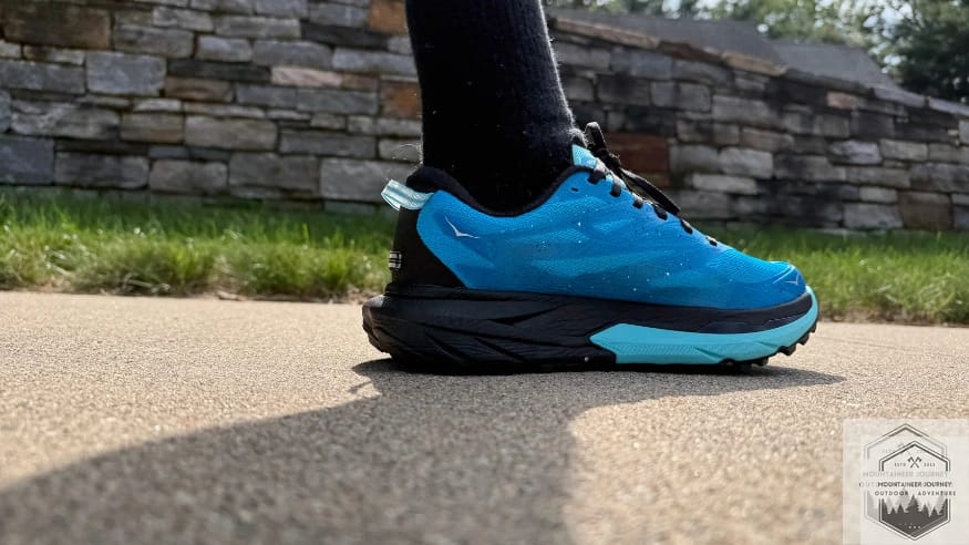 Medial view of Hoka Mafate 5 on concrete showing the gaiter attachment point at the top.