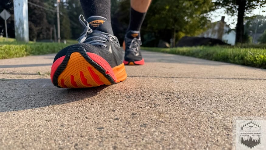 Walking on pavement in the Altra Experience Flow 2 showing the wide FootShape toe box that allows for natural toe splay and foot expansion