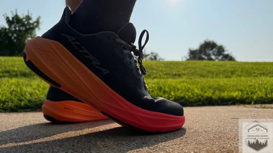 Standing in the Altra Experience Flow 2 on concrete demonstrating the underfoot comfort and rockered outsole geometry