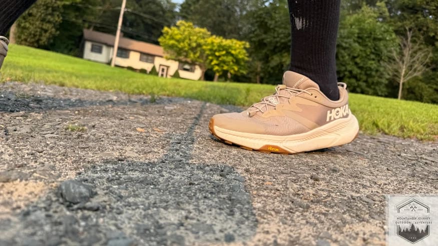 Hoka Transport toe-off phase on concrete demonstrating the Meta-Rocker geometry for a smooth and efficient heel-to-toe transition.