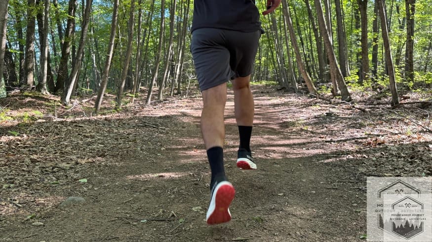 Close-up of the NNormal Kjerag 2 flexing at the forefoot as the runner pushes off the trail surface.