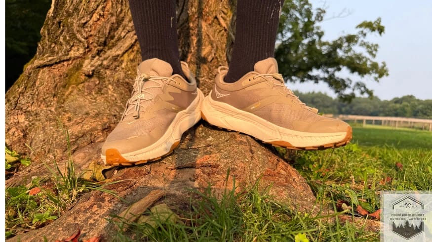 front view of both shoes while standing on a tree root