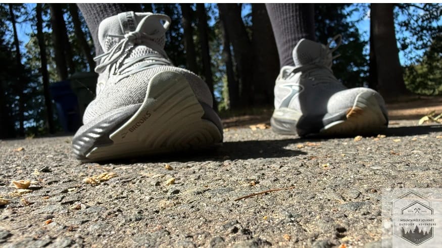 Front view of the Brooks Glycerin 22 on gravel, demonstrating the stability of the widened DNA LOFT v3 platform and secure midfoot lockdown on loose terrain.