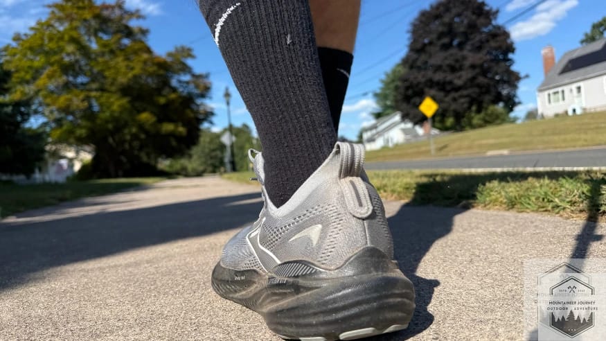 Rear view of the Brooks Glycerin 22 while walking on concrete, highlighting the thick stack of DNA LOFT v3 nitrogen-infused foam for maximum heel cushioning.