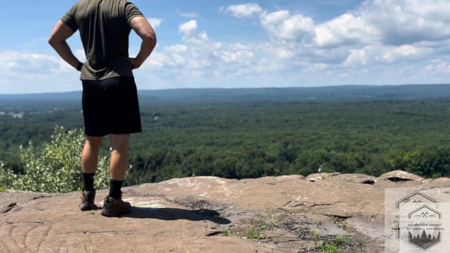 Standing at the top of the summit wearing the Moab 3