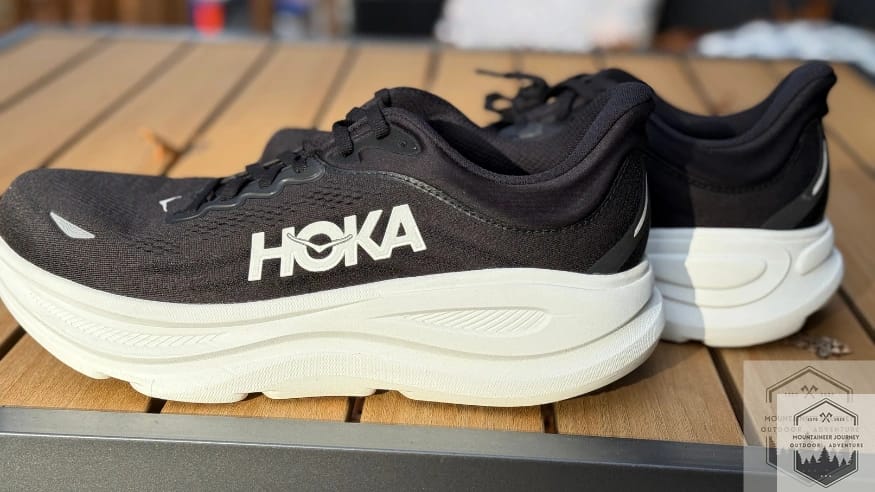 Side profile view of the Hoka Bondi 9 pair showcasing the massive stack height and the signature compression-molded supercritical EVA foam for maximum impact protection.