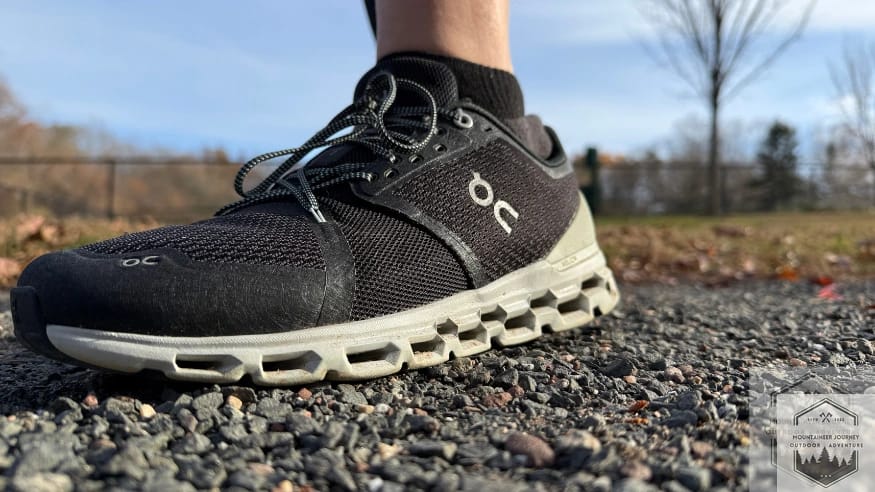 Full front view of the On Cloud 6 on a gravel path, highlighting the breathable engineered mesh upper and the signature speed lacing system for a secure, adjustable fit.