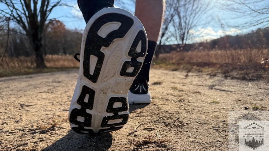 View of the Dura-Bridge and outsole on mixed sand and gravel showing no debris getting caught in the outsole as well as kicking up the gravel during testing